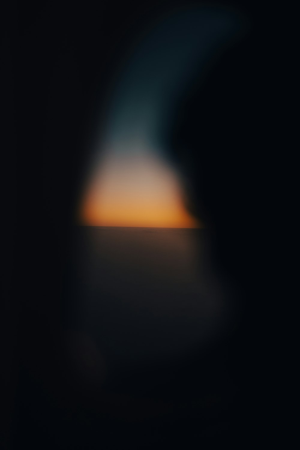 a blurry photo of the sun setting over the horizon
