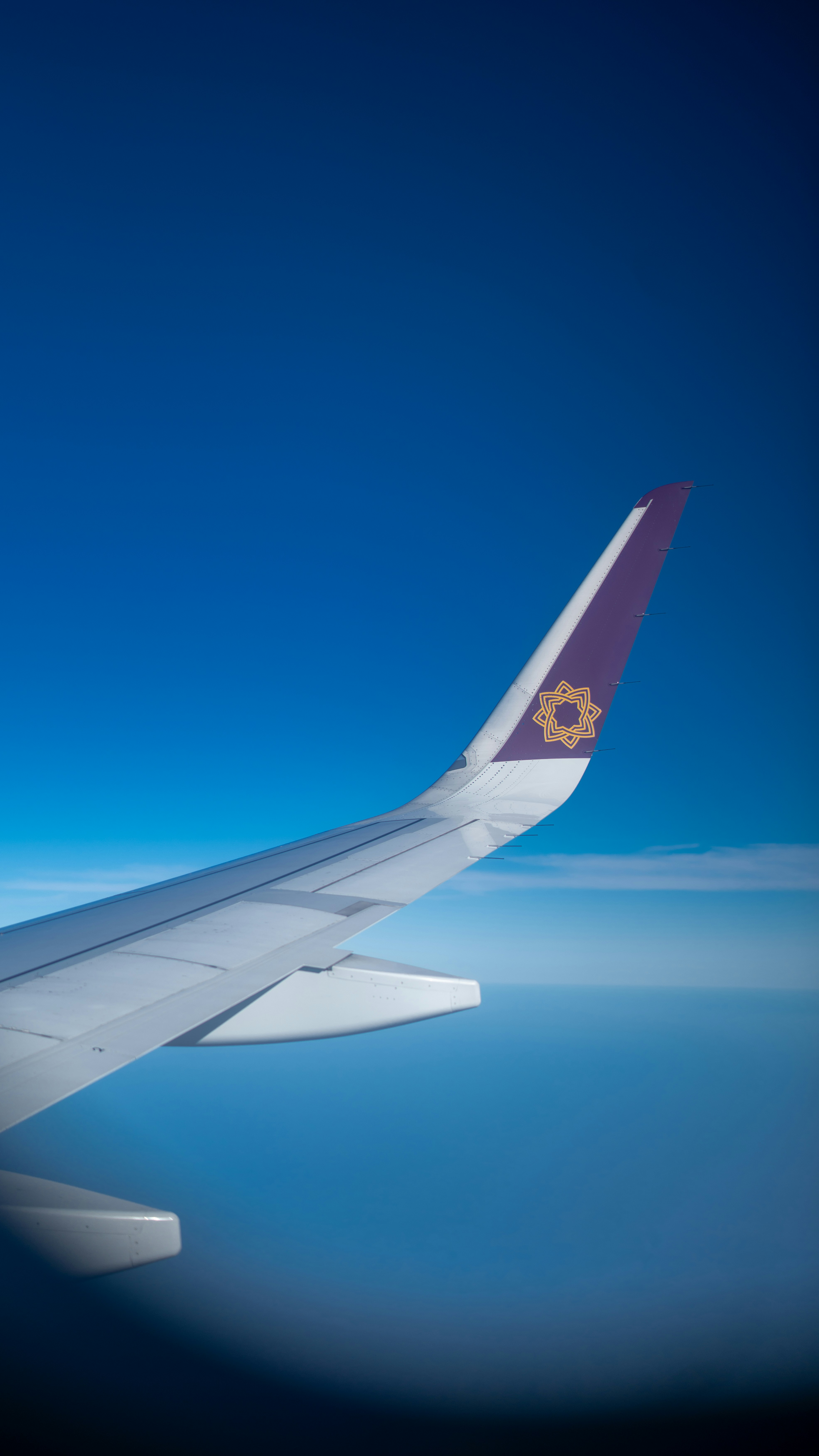 a view of the wing of an airplane in the sky