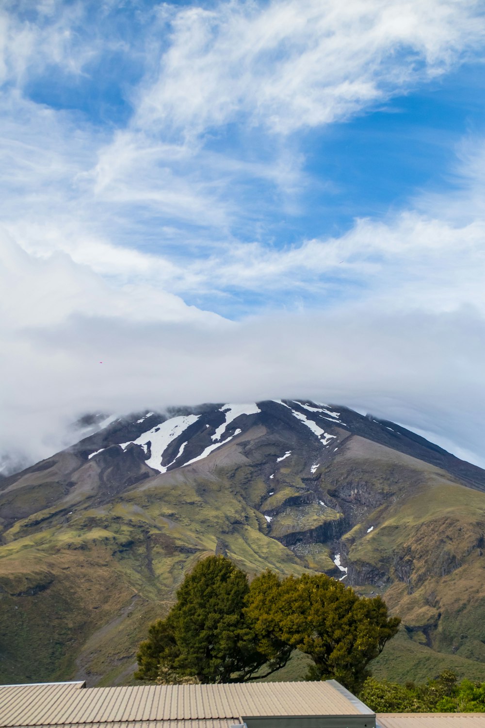 a view of a snow covered mountain from a house