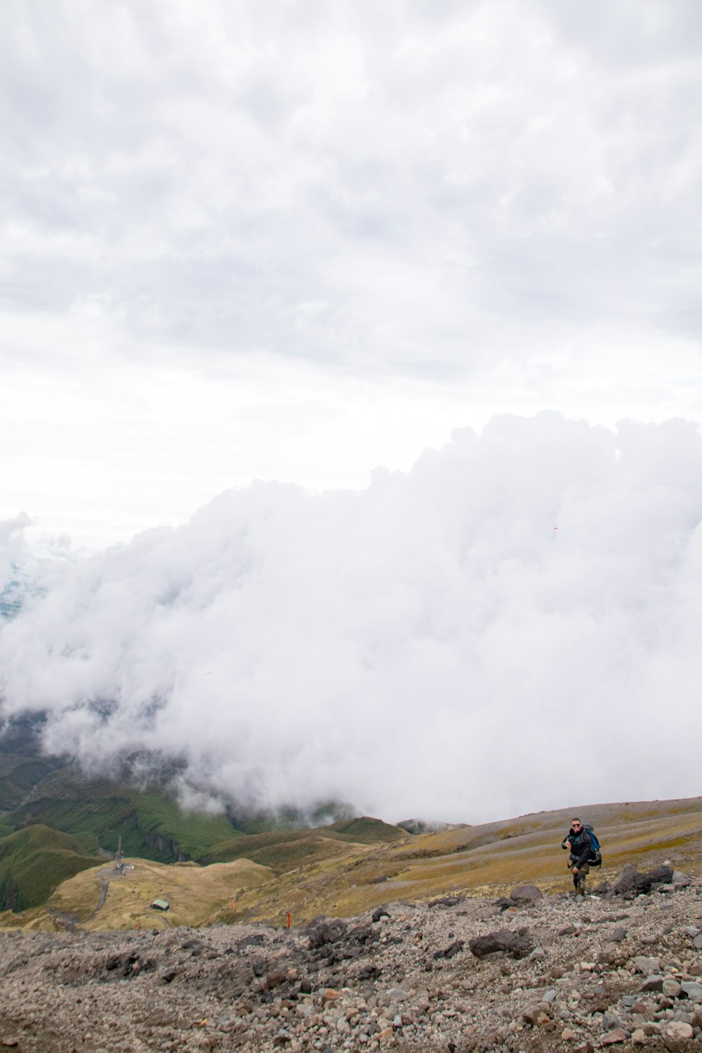 a man standing on top of a rocky hillside