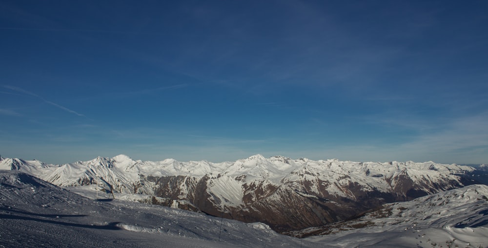 a view of a mountain range from a ski slope