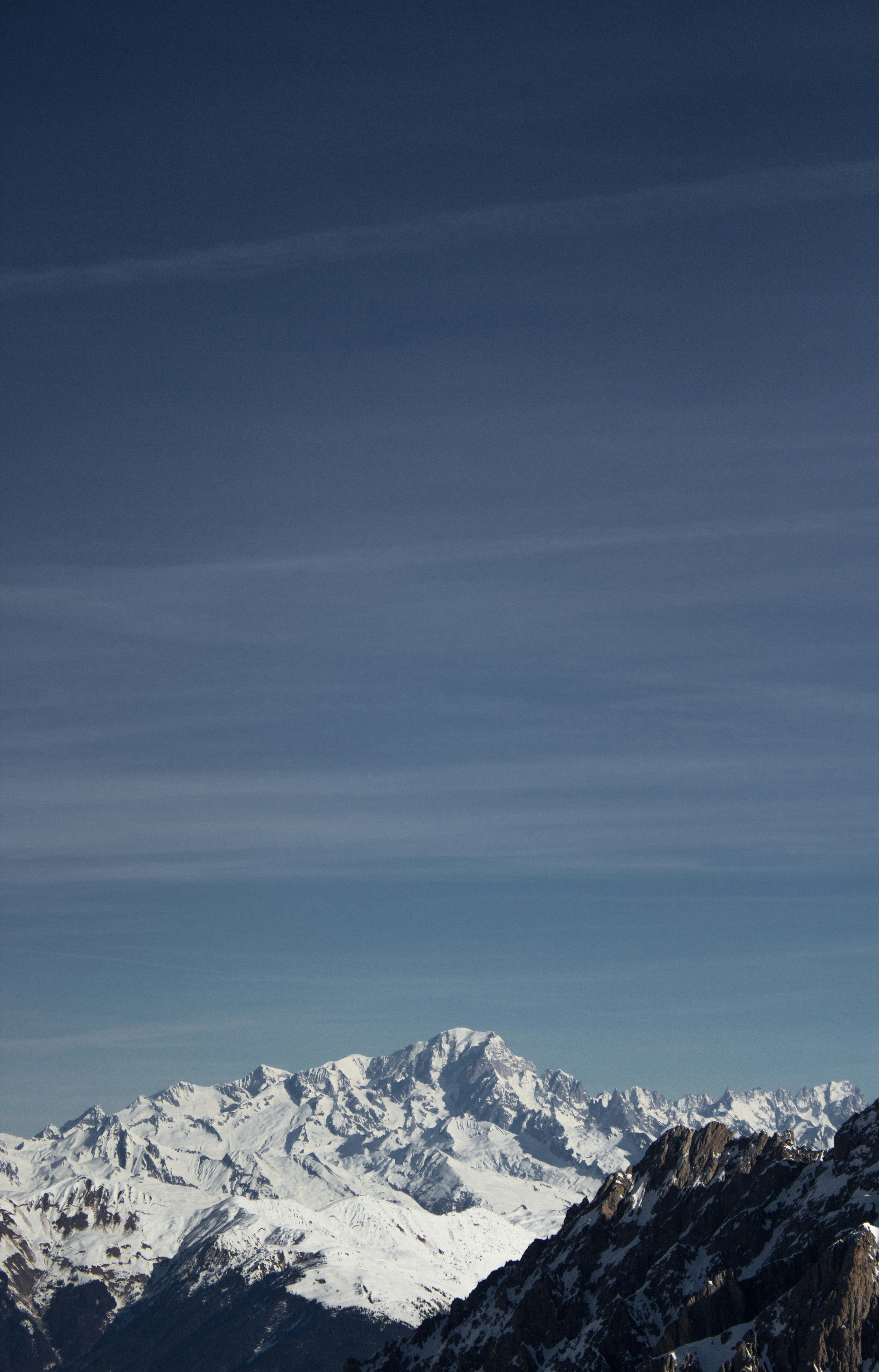 a man riding skis on top of a snow covered slope
