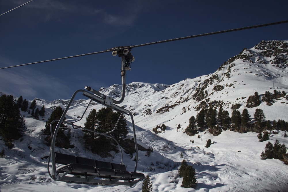 un telesilla subiendo a una montaña nevada