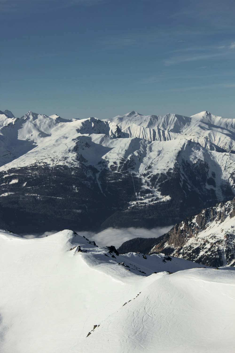 a man standing on top of a snow covered mountain