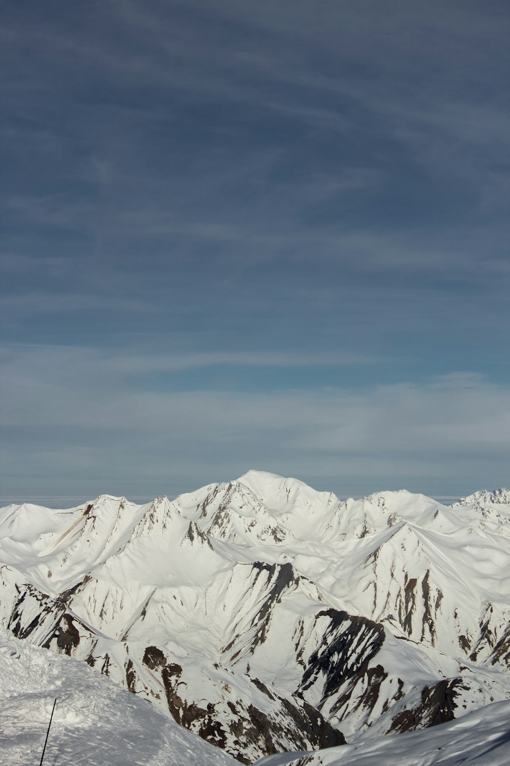 a man riding skis on top of a snow covered slope