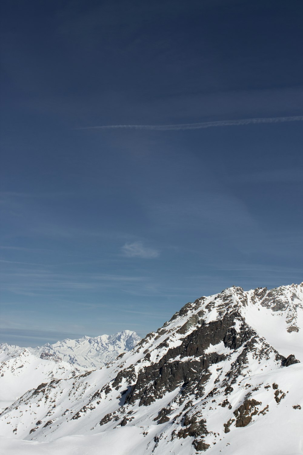 a man riding skis on top of a snow covered slope