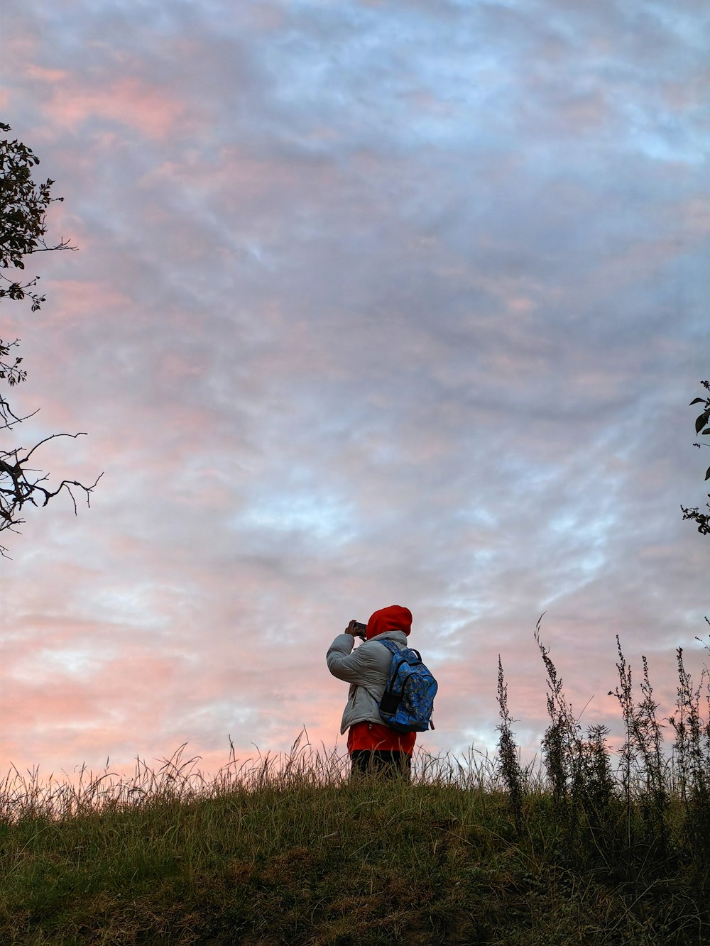 a person with a backpack standing on a hill