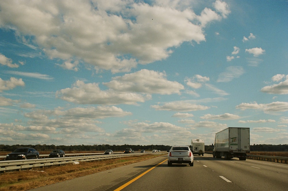 a highway with cars and a truck on it