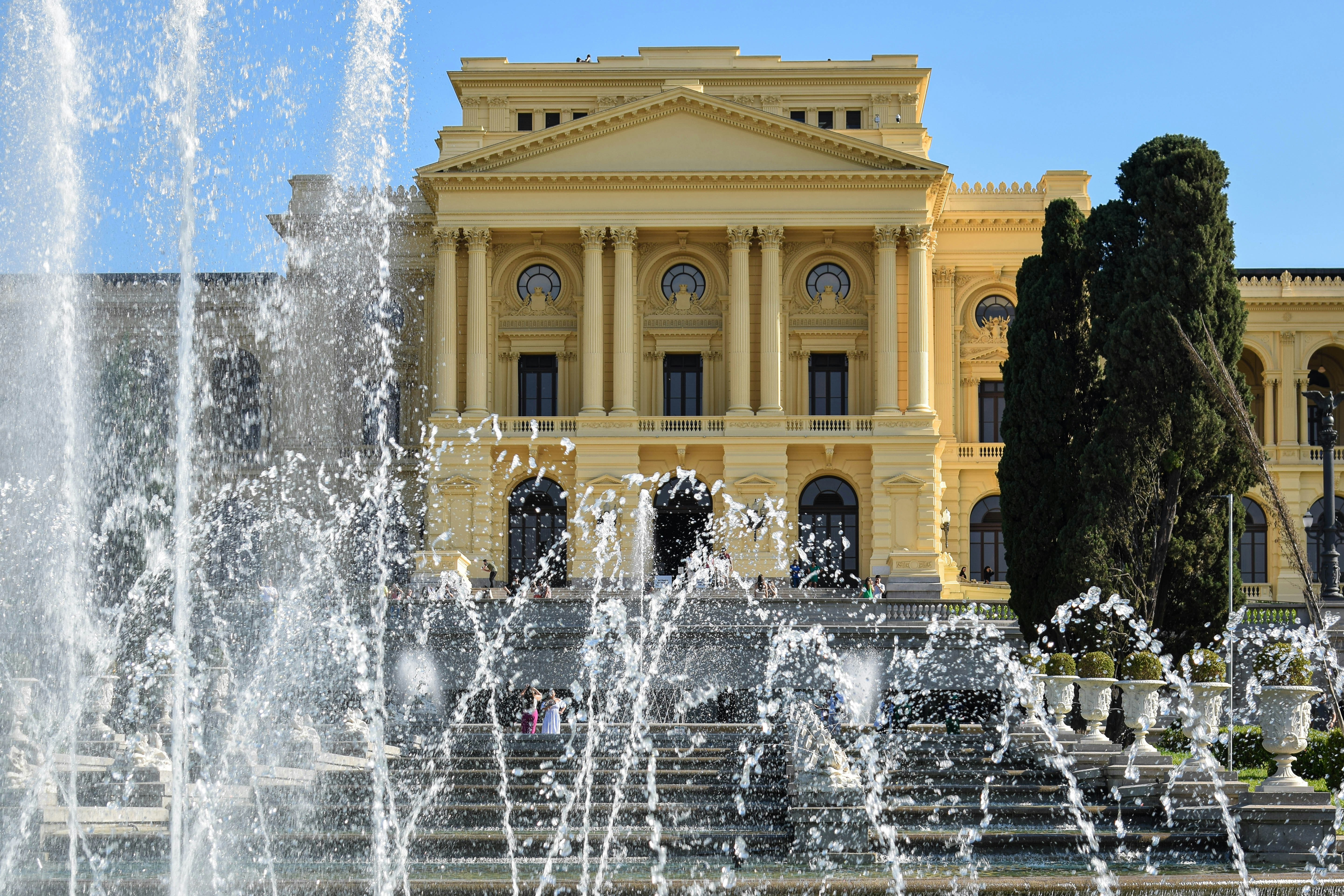 a large building with a fountain in front of it