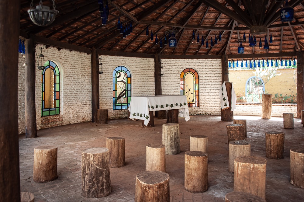 a room filled with wooden stumps and stained glass windows
