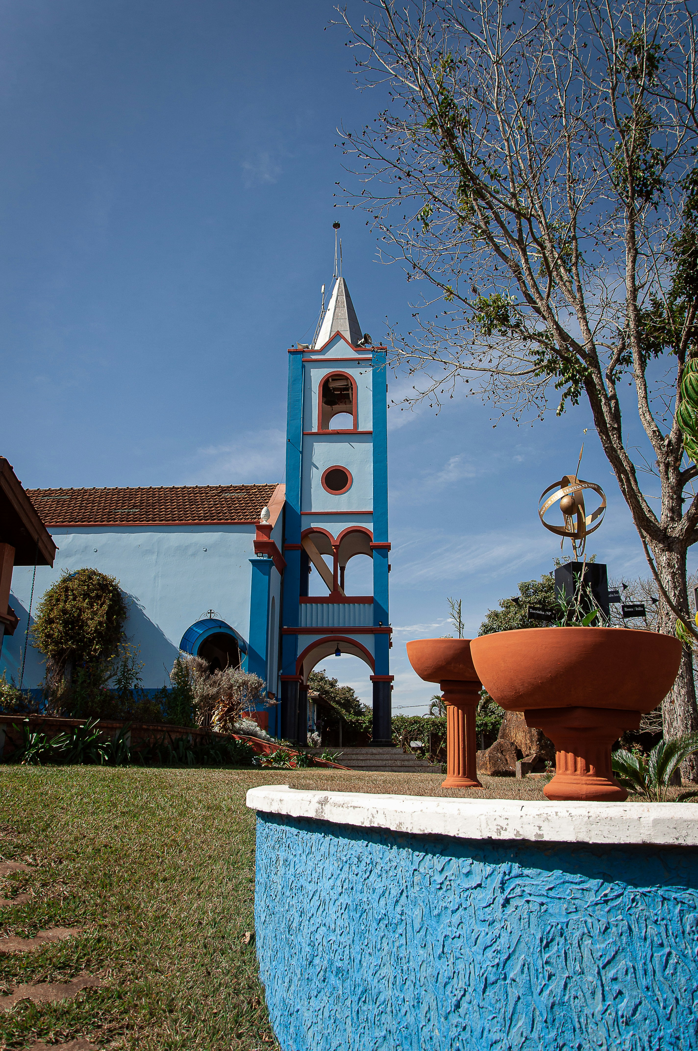 a blue building with a clock tower in the background