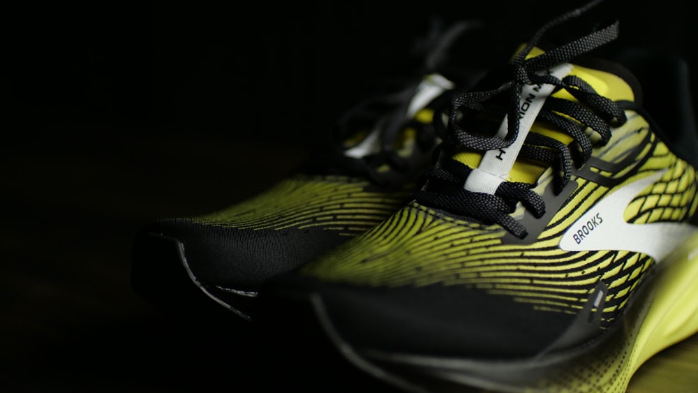 a pair of yellow and black shoes on a table