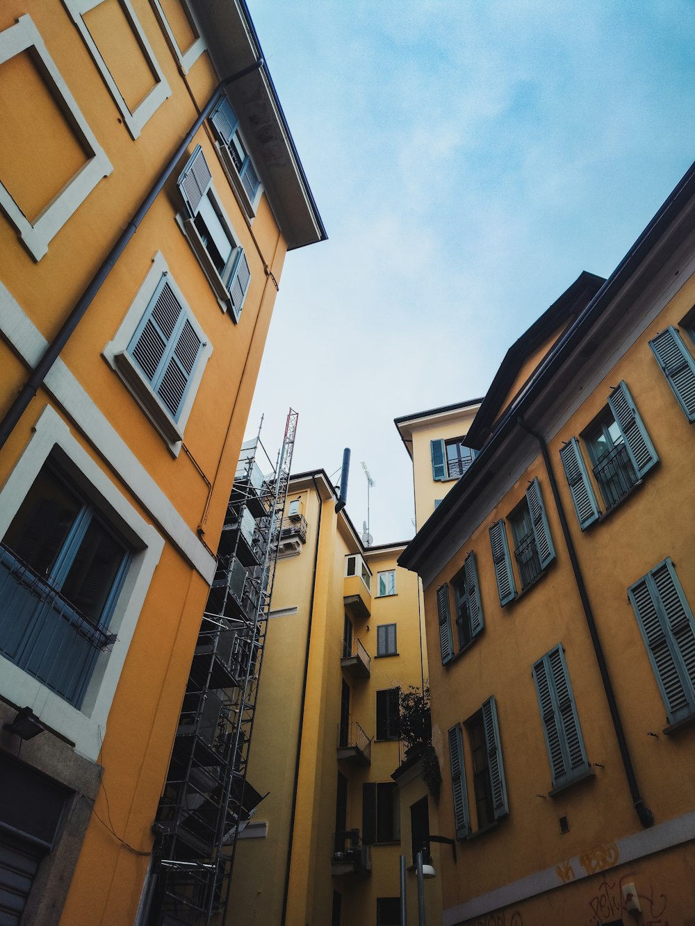 a tall yellow building next to a tall yellow building