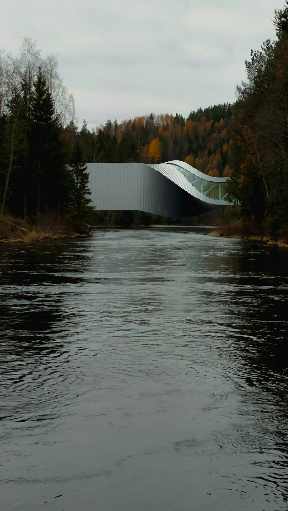 a bridge over a river with a building in the background