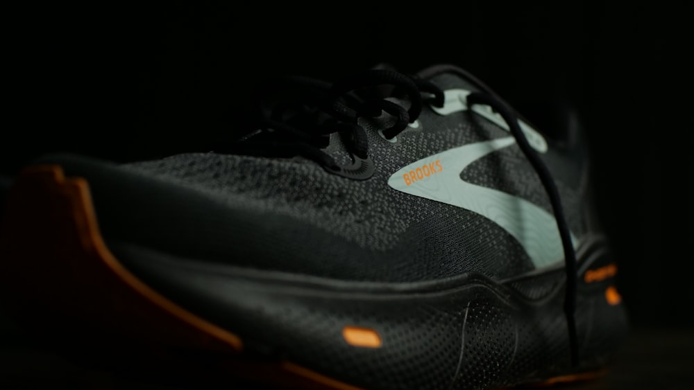 a pair of black and orange running shoes