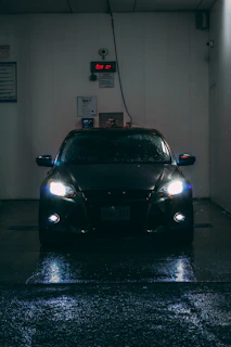 a car is parked in a dark garage