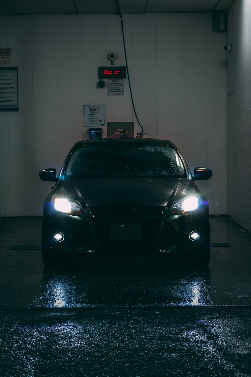 a car is parked in a dark garage