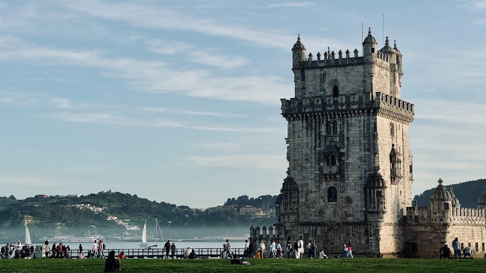 a group of people standing in front of a tall tower