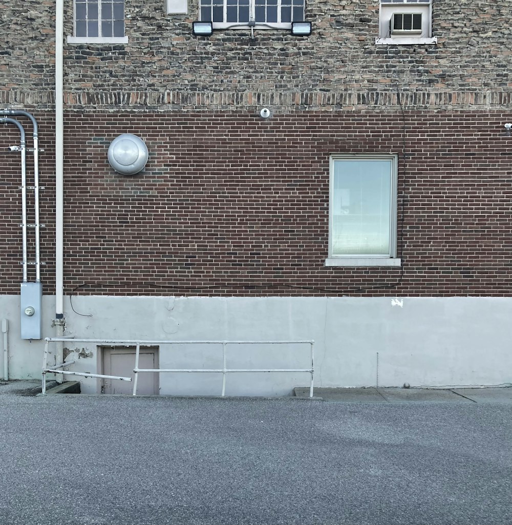 an empty parking lot next to a brick building