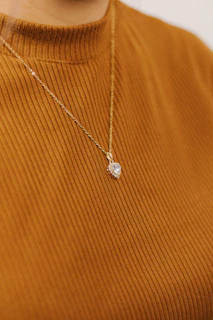 a close up of a person wearing a necklace