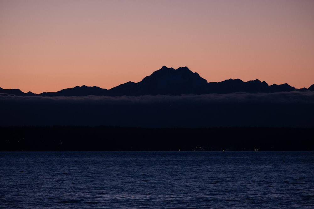 a view of a mountain in the distance from a body of water