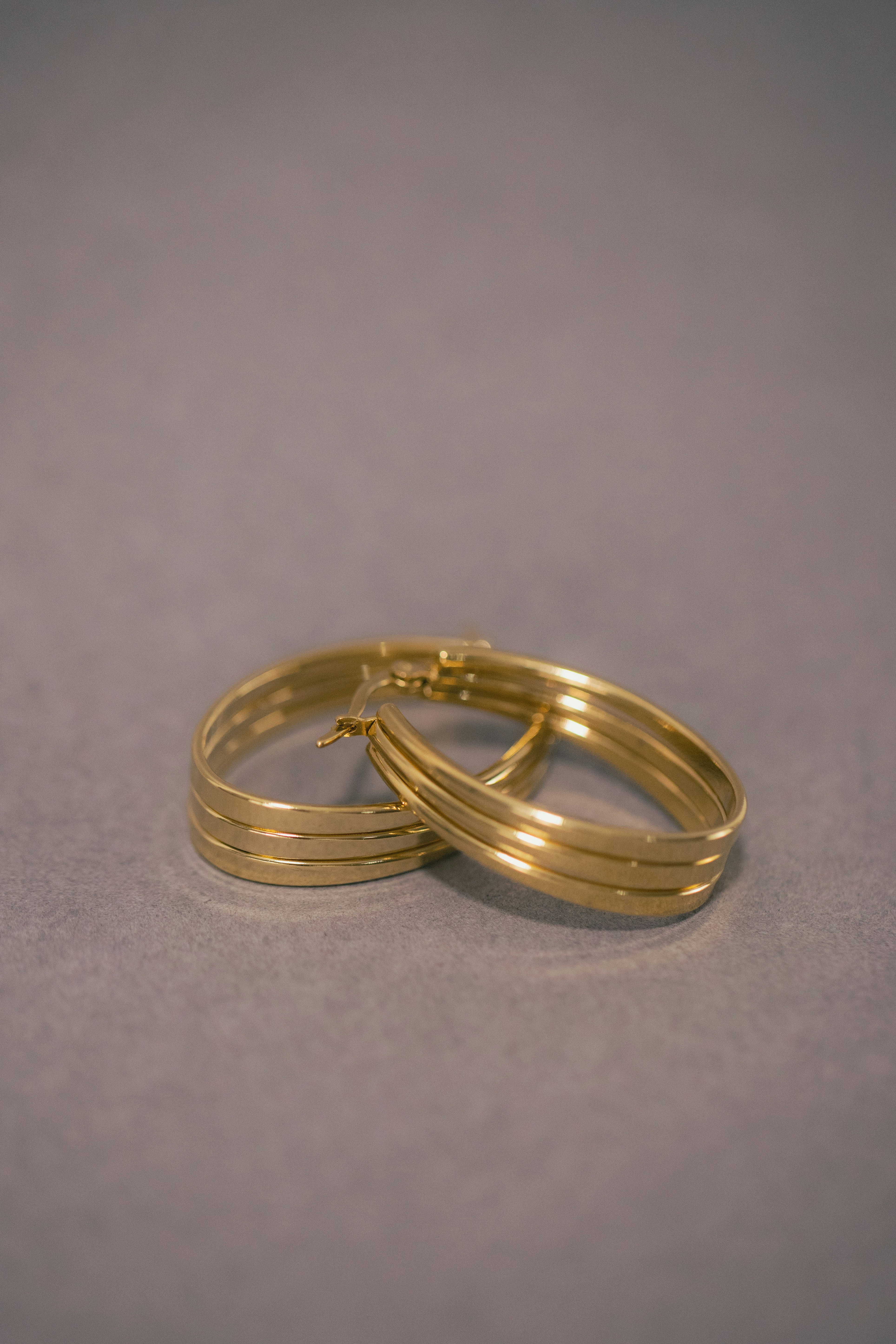 a couple of gold rings sitting on top of a table