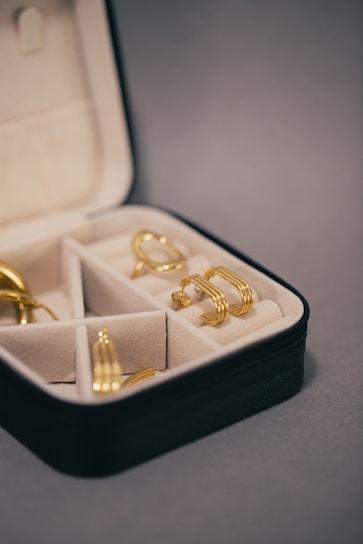 a box with four pairs of gold rings in it
