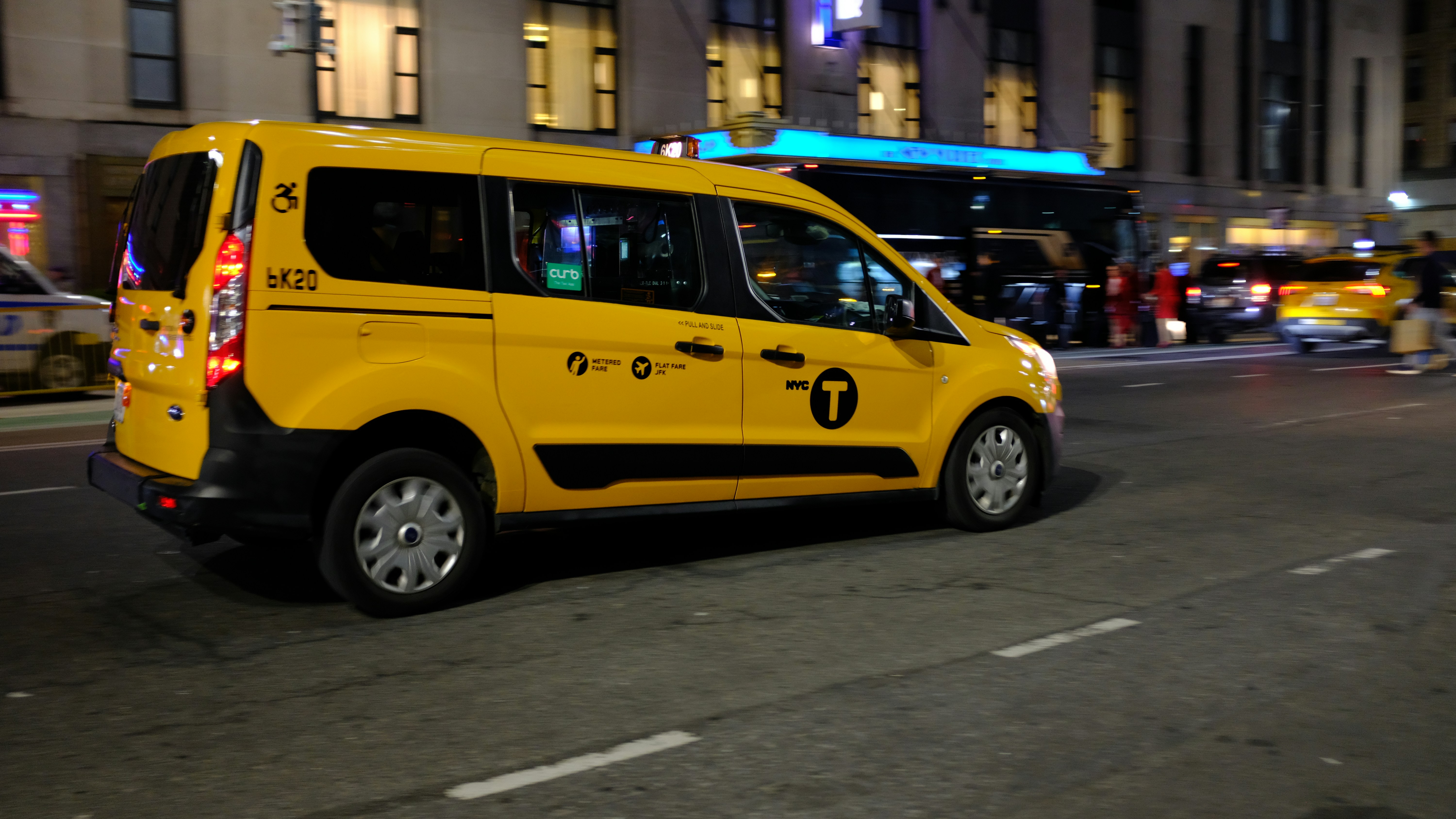 Professional taxi cab on Delhi road at night with city lights