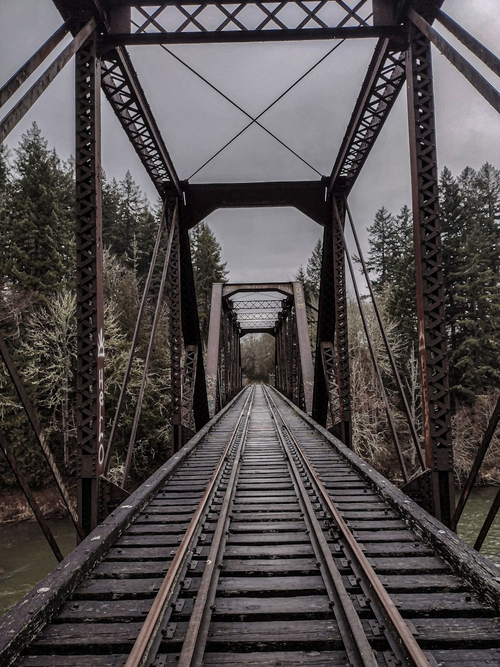 a train track going across a bridge over a river