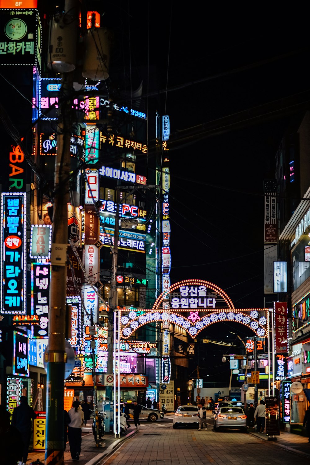 a city street filled with lots of neon signs