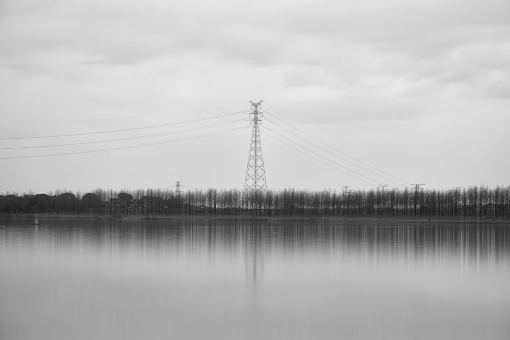 a large body of water with power lines in the background