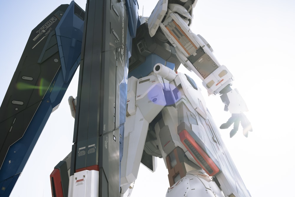 a giant robot standing next to a tall pole