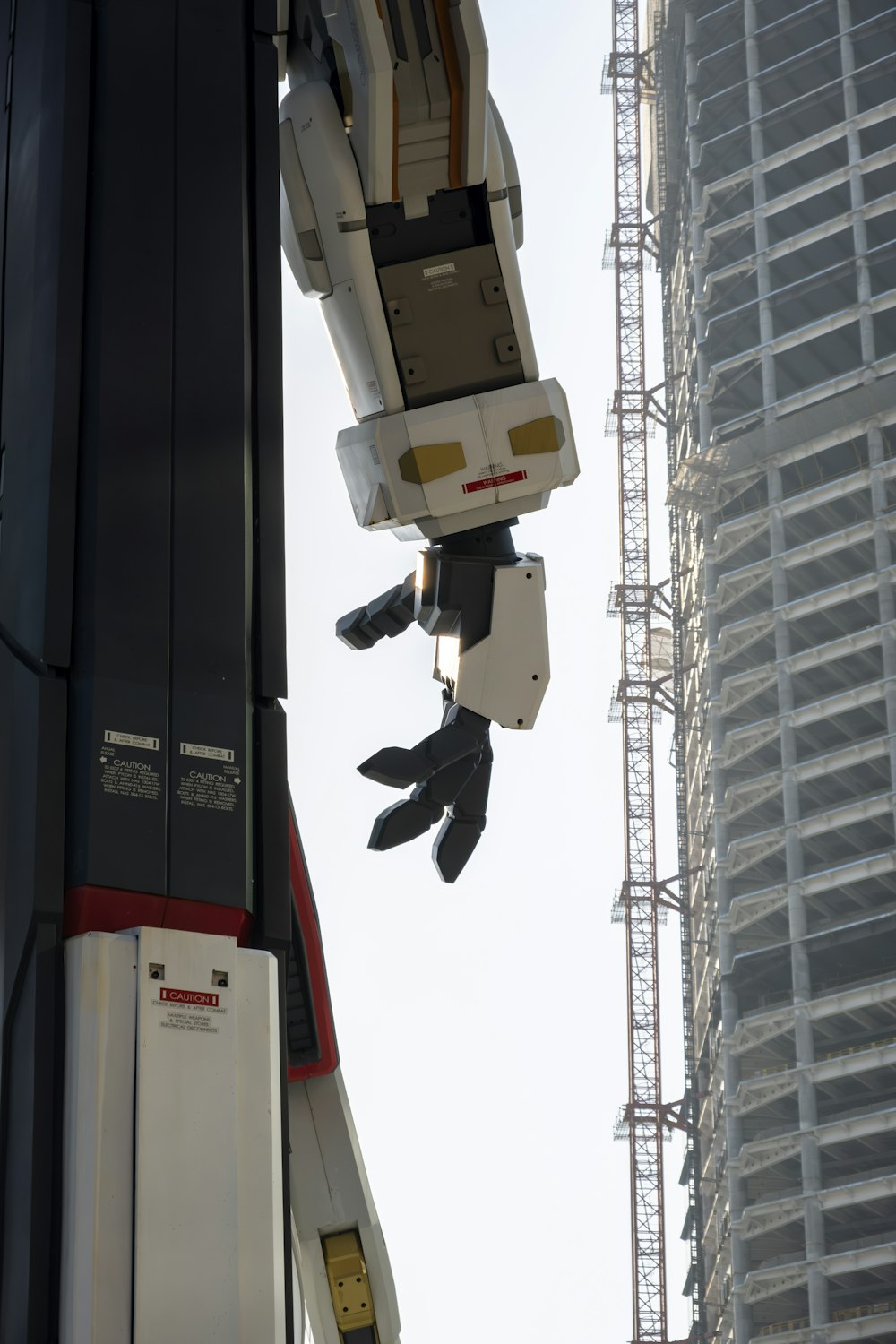 a robot hanging from the side of a tall building