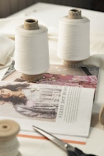 two spools of thread sitting on top of a table
