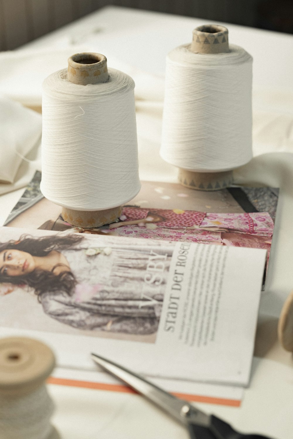 two spools of thread sitting on top of a table