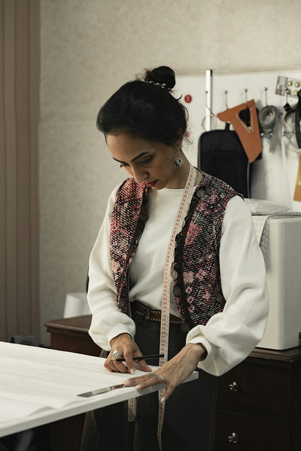 a woman in a white shirt and black pants holding a piece of paper