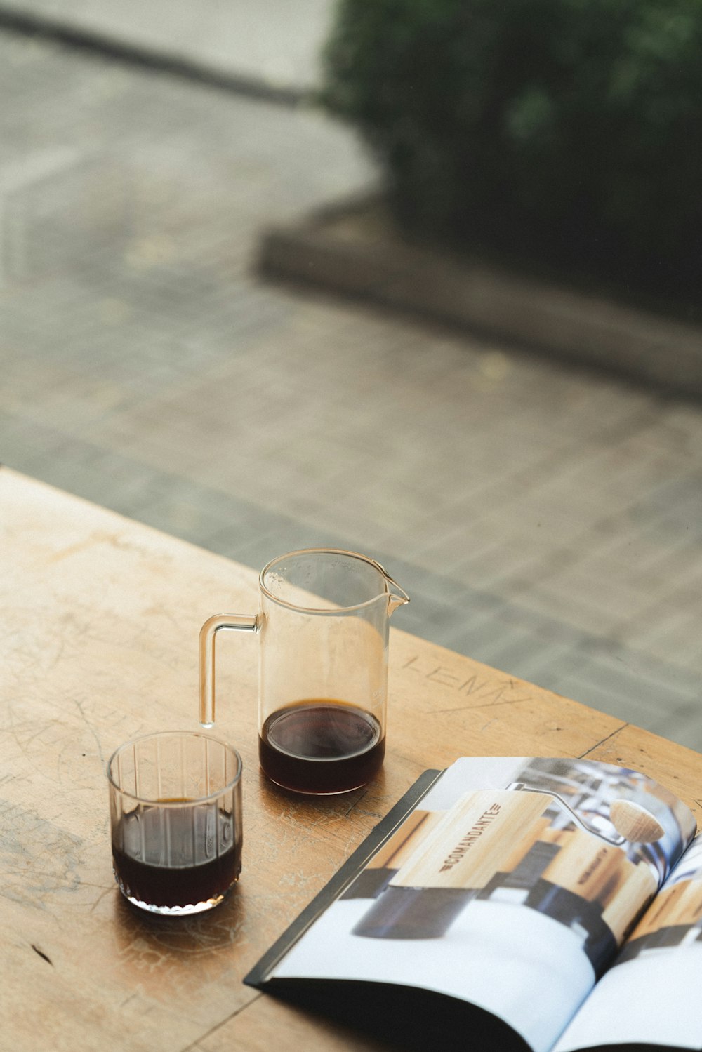 a book and a glass of wine on a table