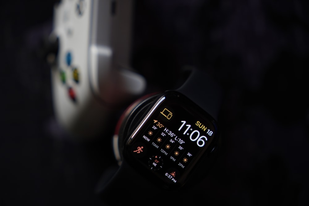 a smart watch sitting next to an iphone