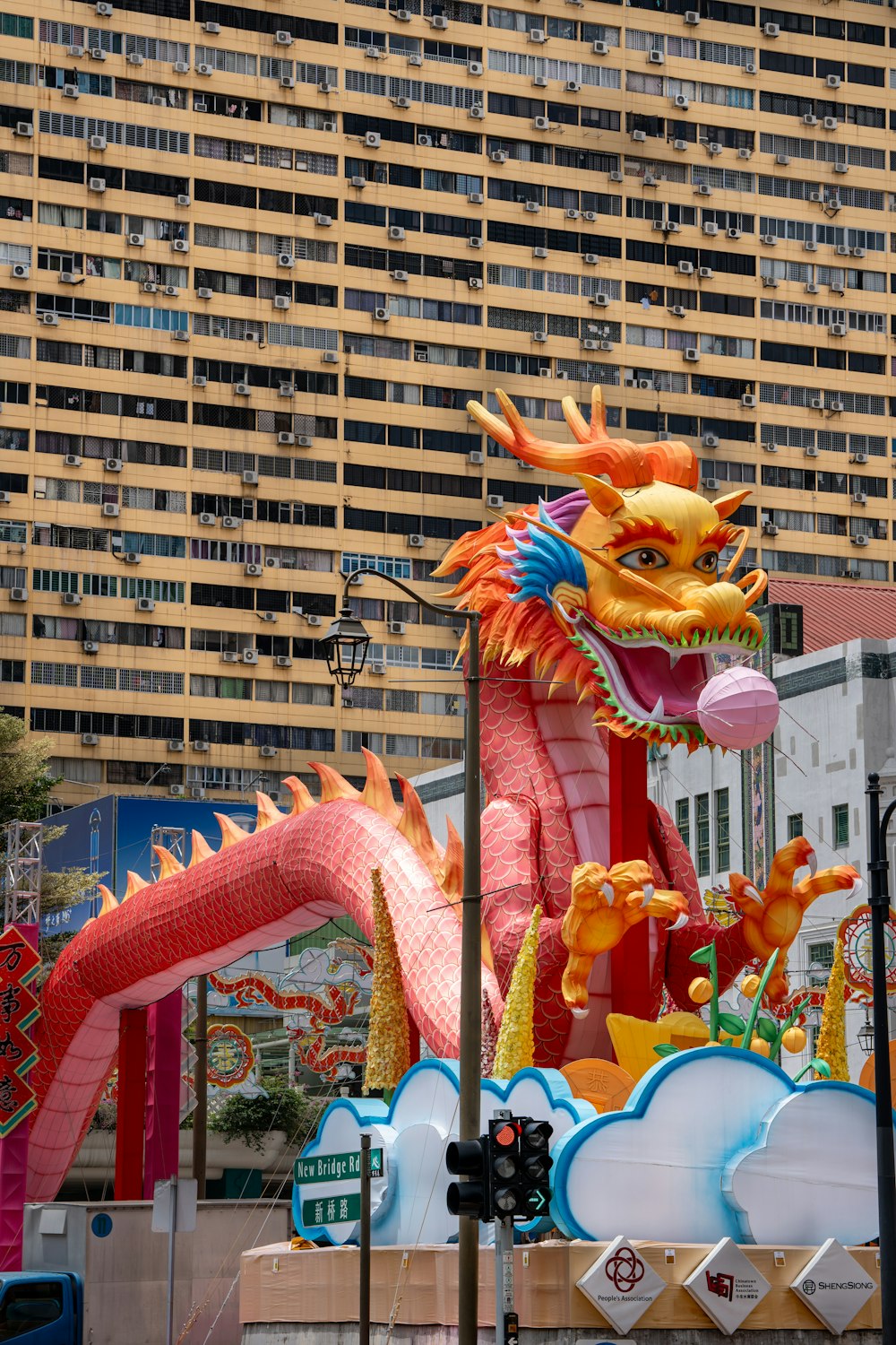 a large dragon statue in front of a tall building