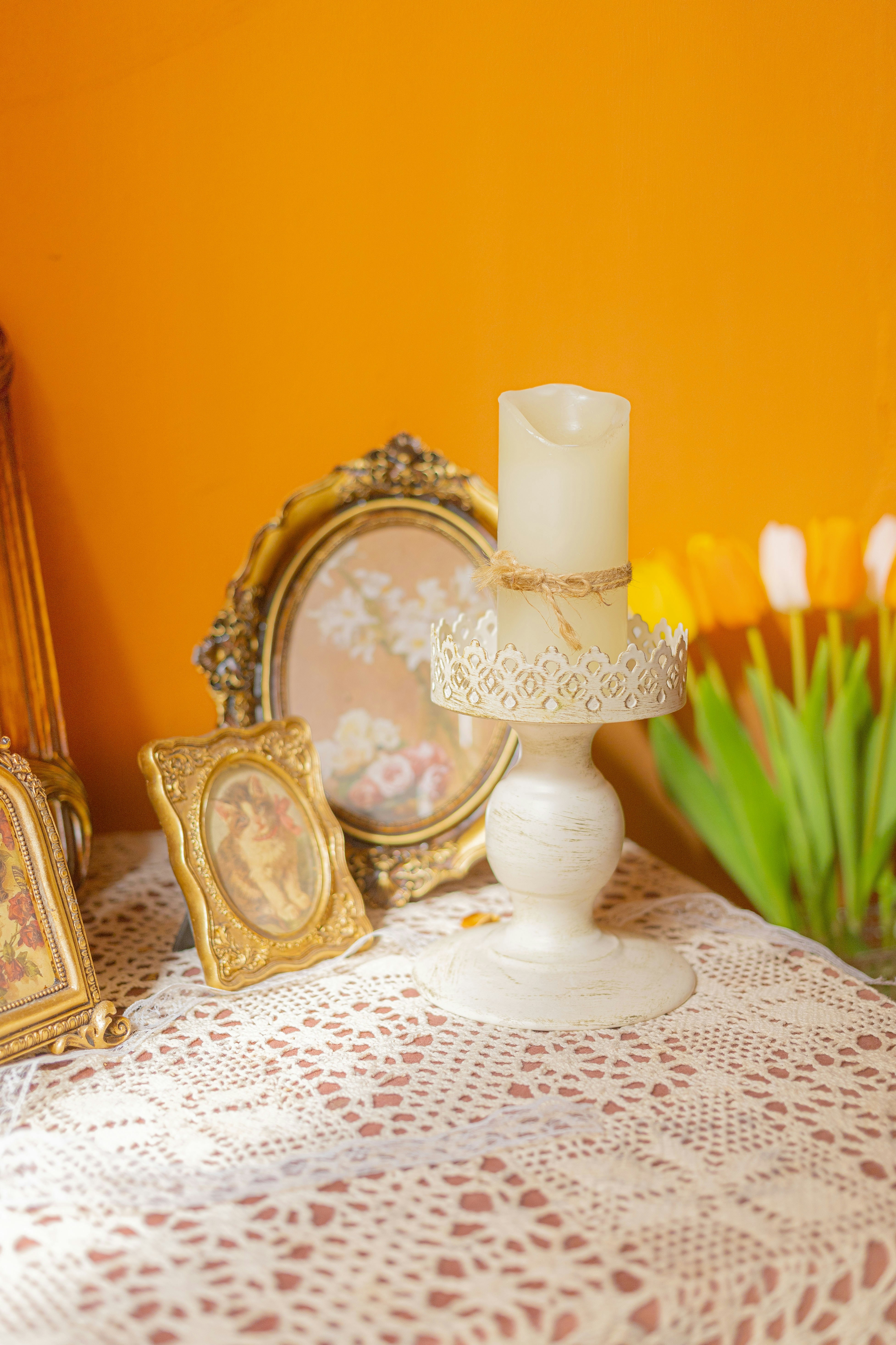 a table topped with a white cake next to pictures