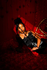 a woman laying on a bed in a dark room