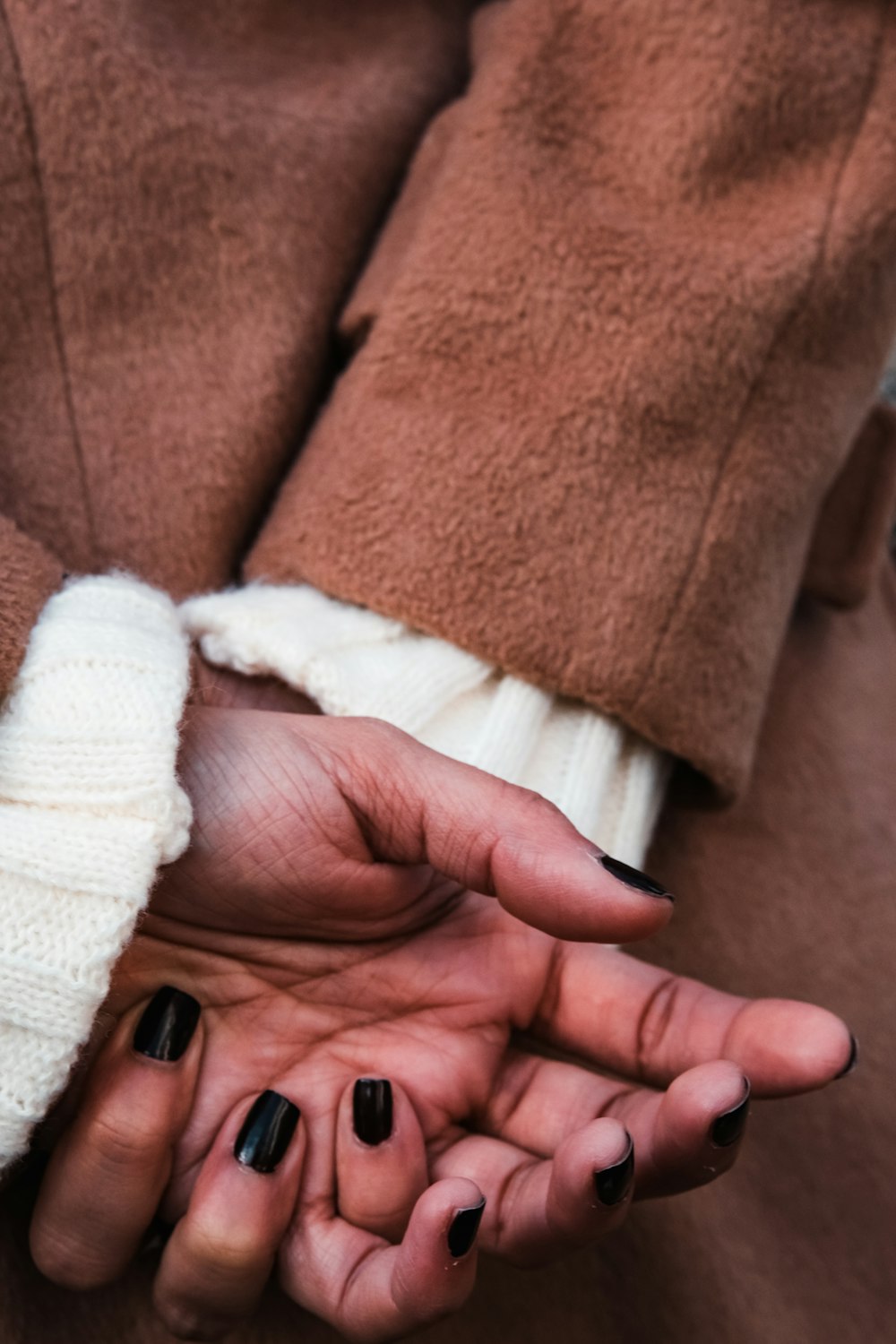 a woman's hands with black and white manicures