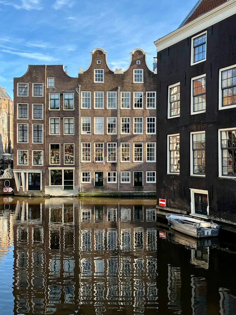 a row of buildings next to a body of water