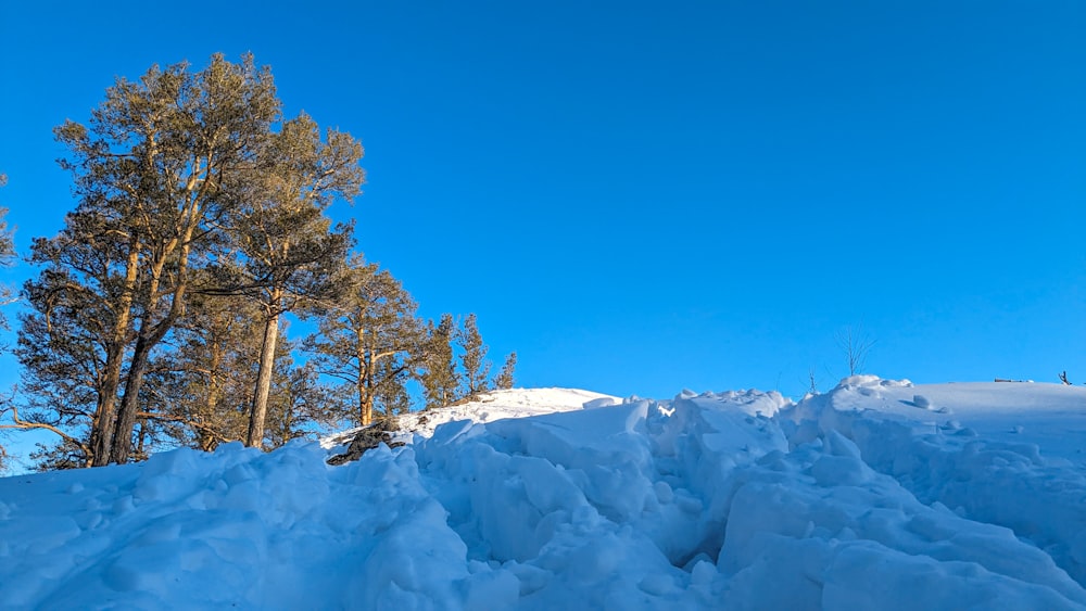 a man riding a snowboard down a snow covered slope