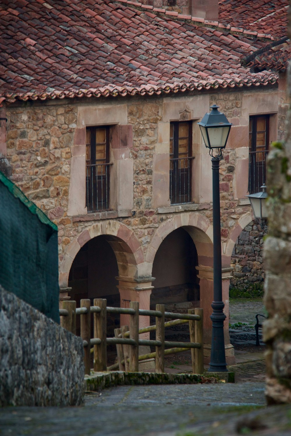 a stone building with a lamp post in front of it