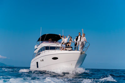a group of people riding on the front of a big yacht
