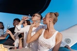 a group of people sitting at a table drinking wine
