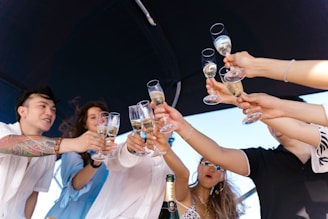 a group of people holding up wine glasses