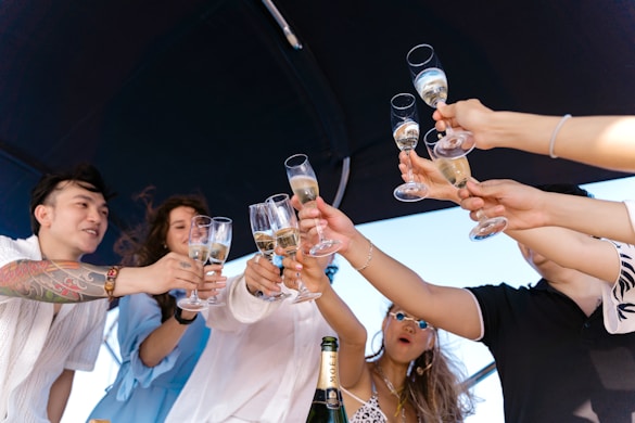 a group of people holding up wine glasses