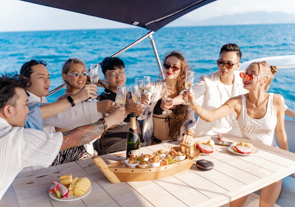 a group of people sitting around a table on a boat